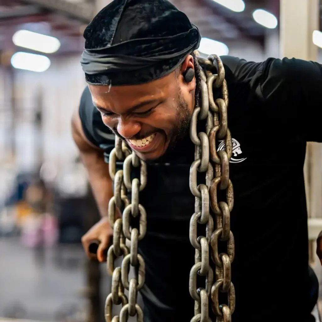 Monthly Brand Content 4 a man with a chain around his neck doing dips at the gym