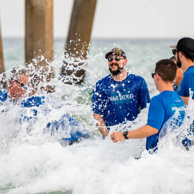 Corporate Event Photography & Videography in Pensacola | KDH Productions 7 Hillcrest beach baptism event photography people in blue shirts in water at the beach being baptised