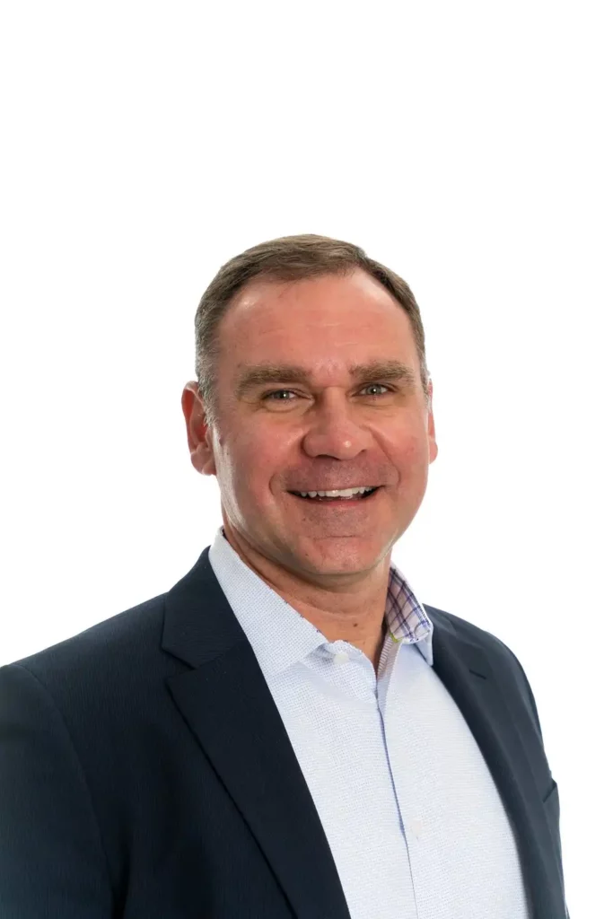 Business Headshots & Team Portraits 1 Executive headshot on a clean white backdrop, navy jacket and open collar