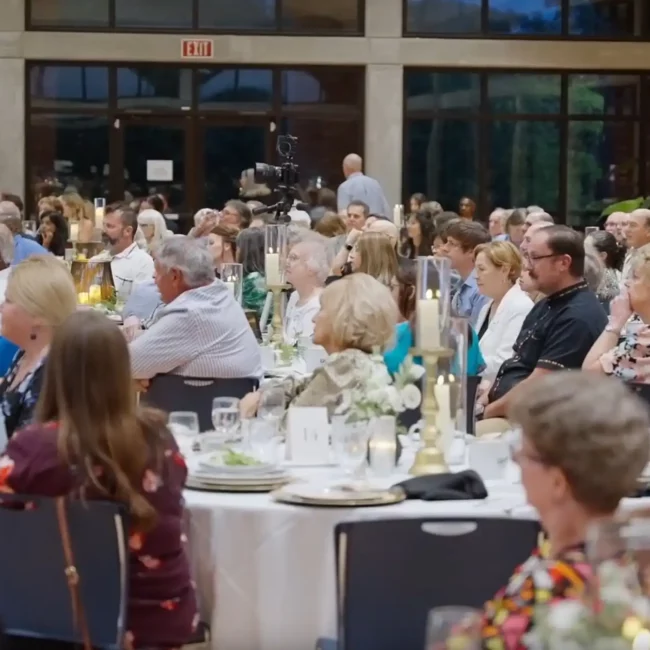 Corporate Event Photography & Videography in Pensacola | KDH Productions 1 a group of people sitting at tables