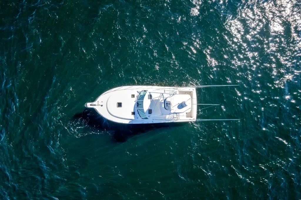 Marine Photography 7 Directly overhead drone frame of a sportfishing yacht, showing deck layout, cockpit and hull lines against dark water