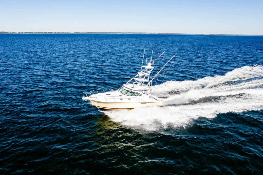 Sportfishing Tournament Video 6 Profile of a sportfishing yacht running hard, wake curling out behind her