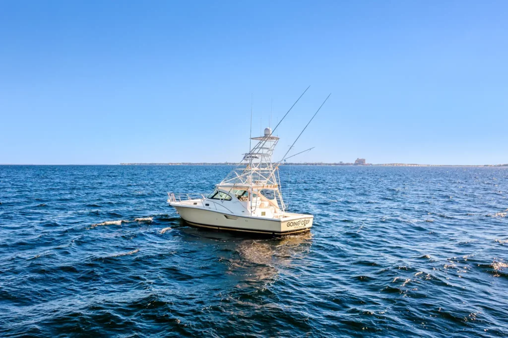 Sportfishing Tournament Video 4 Bow-on view of a sportfishing yacht sitting still offshore, tower and outriggers silhouetted