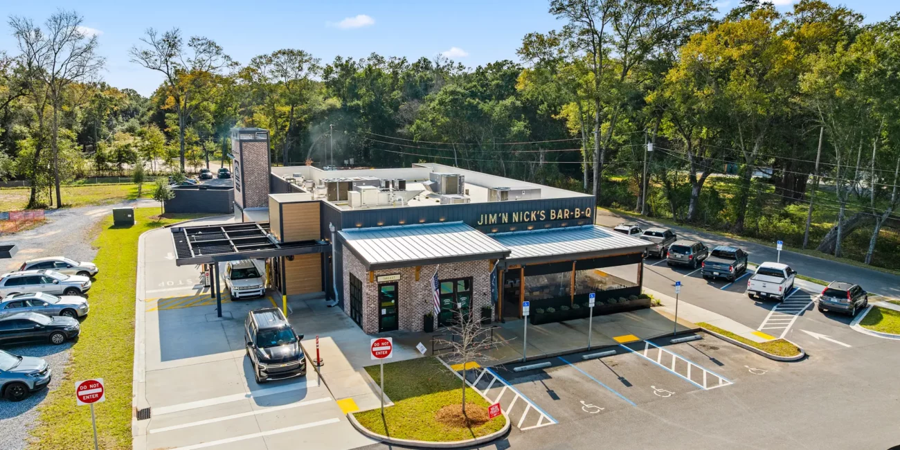 Real Estate 4 Jim-N-Nicks 4625 US-90, Pace, FL 32571 exterior drone shot with a packed parking lot full of cars