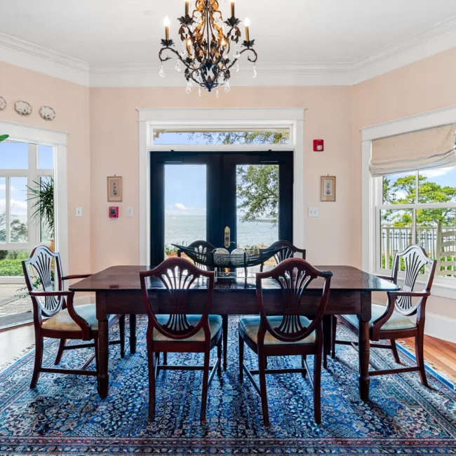 Dining room with a chandelier and French doors at Emma's Bayhouse bed and breakfast in Fairhope