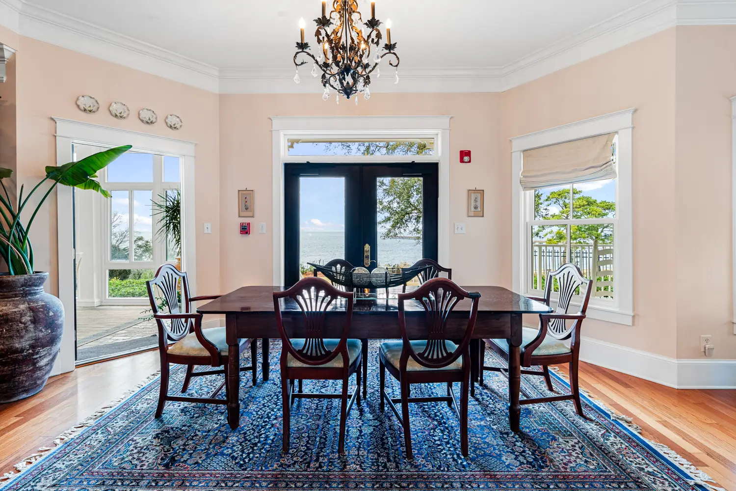 Dining room with a chandelier and French doors at Emma's Bayhouse bed and breakfast in Fairhope