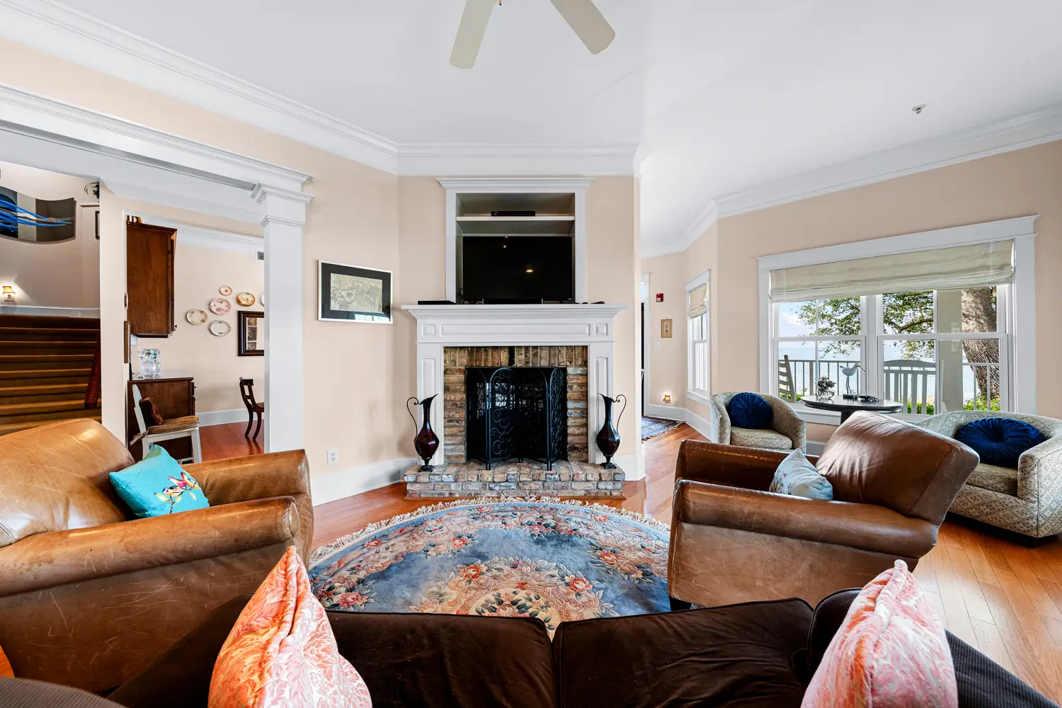 Guest living room with leather sofas and a fireplace at Emma's Bayhouse in Fairhope, Alabama